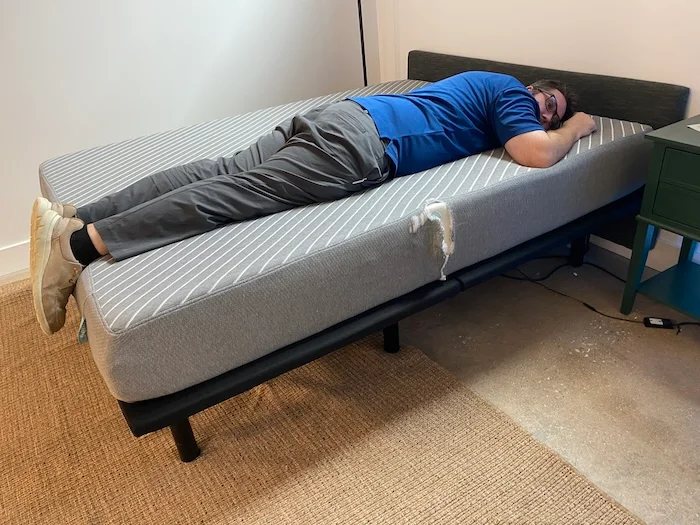 A man lying on his stomach on the Leesa Original mattress.