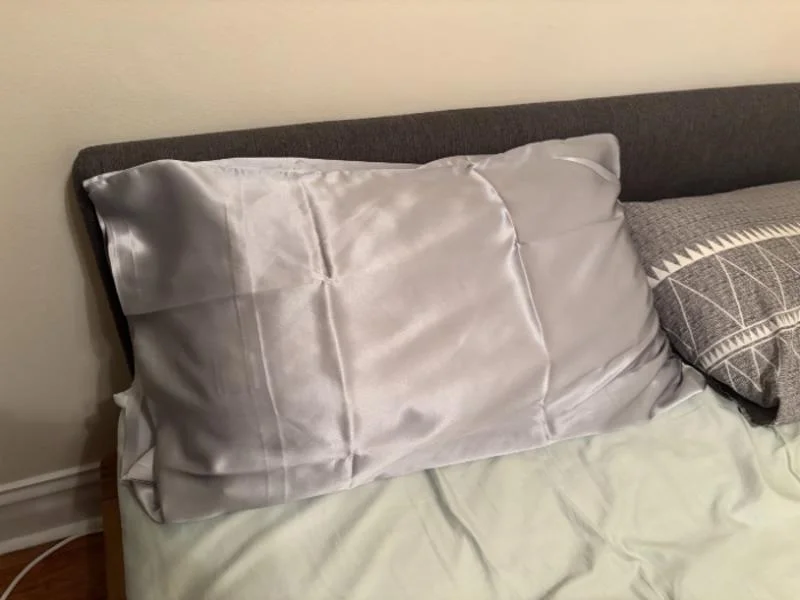A Cozy Earth Silk Pillowcase on a bed at the Sleepopolis studio