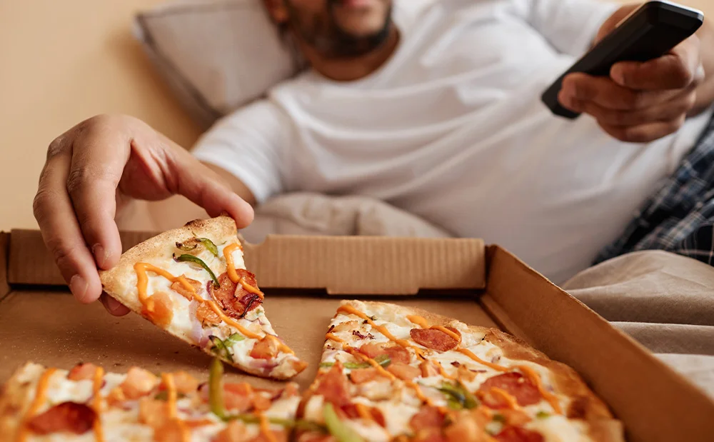 person eating pizza before bed