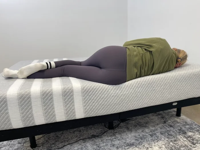 A woman sleeping on her side on the Leesa Original mattress.