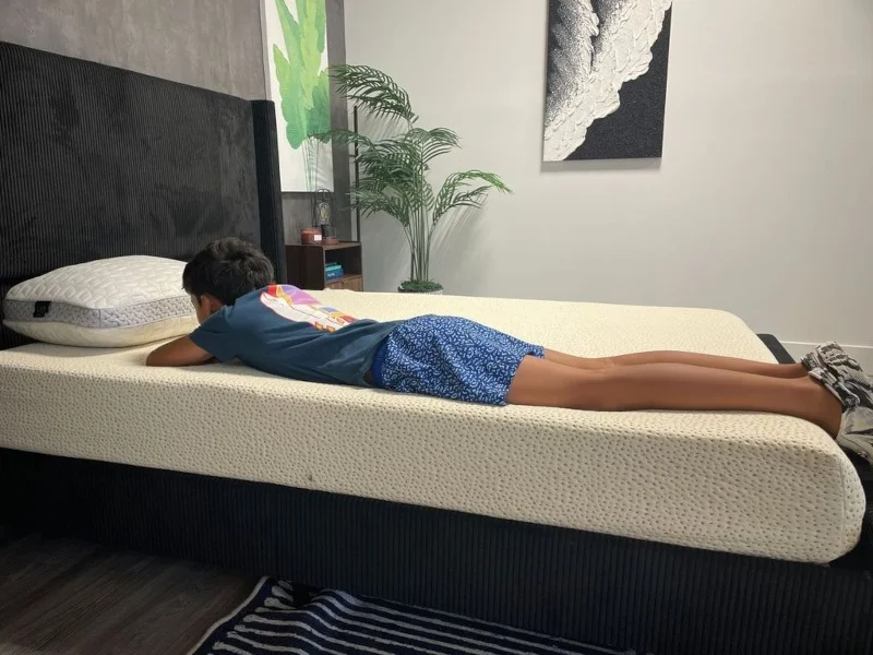 Our tester stomach-sleeping on a 5 Little Monkeys Memory Foam Mattress