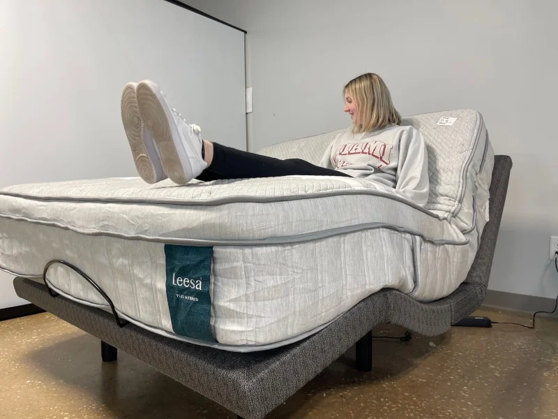 A person using a Leesa Plus Hybrid mattress on an adjustable platform bed frame