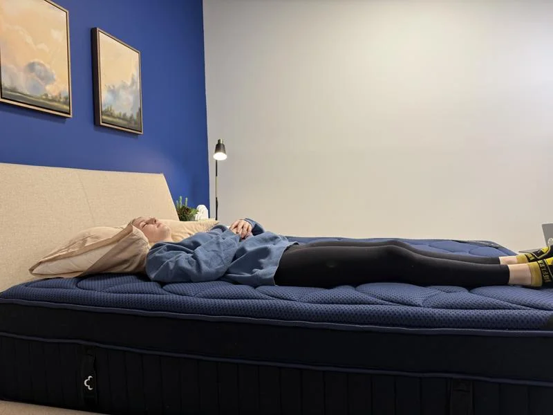 Our tester back-sleeping on the DreamCloud Ultra Hybrid Mattress