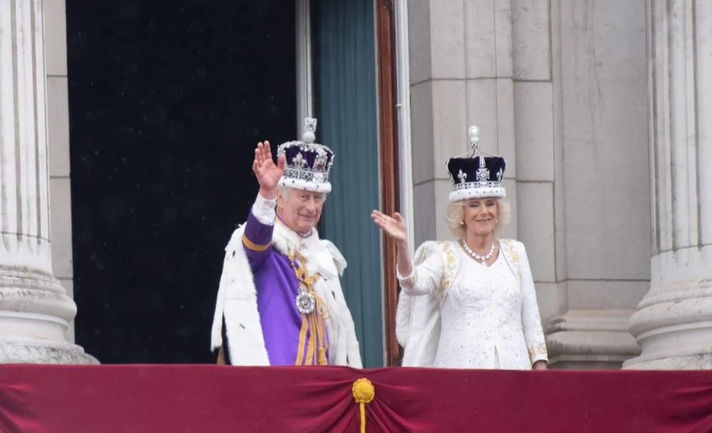 king charles and queen camilla king charles and queen camilla waving from a balcony