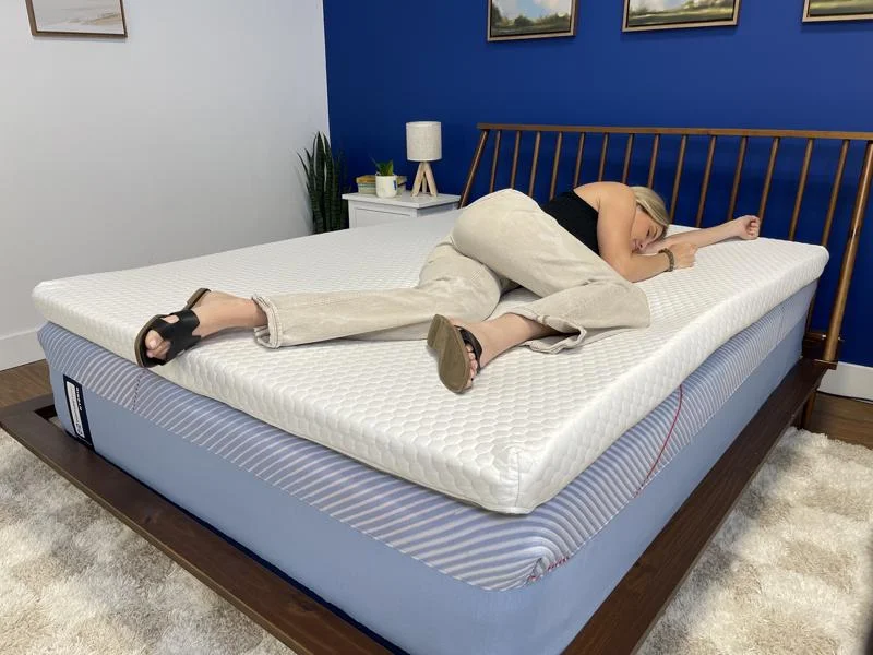 Our product tester side-sleeping on a Bear Pro Topper