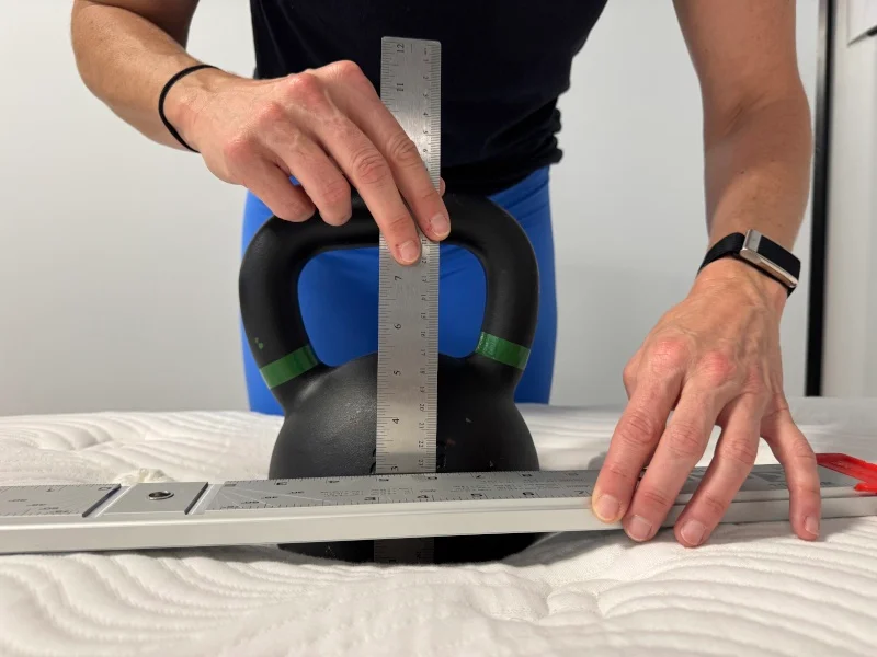 Our tester conducts a sinkage test on the Big Fig Classic Mattress.