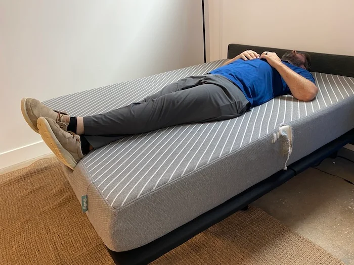 A man lying on his back on the Leesa Original mattress.