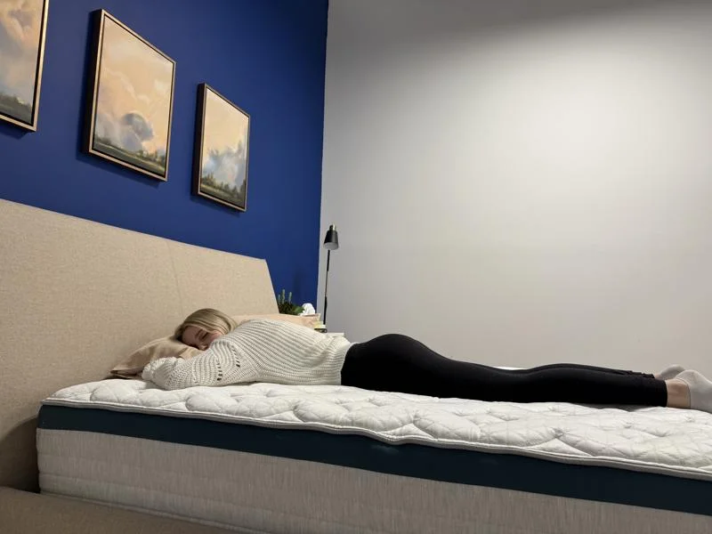 Our tester stomach-sleeping on the Helix Twilight Mattress