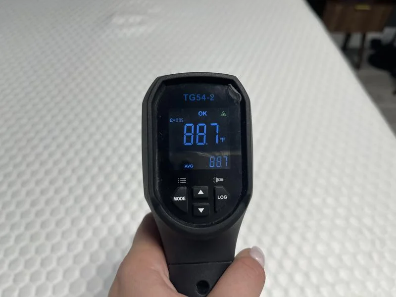 Our tester taking thermal readings of the Bear Pro Topper