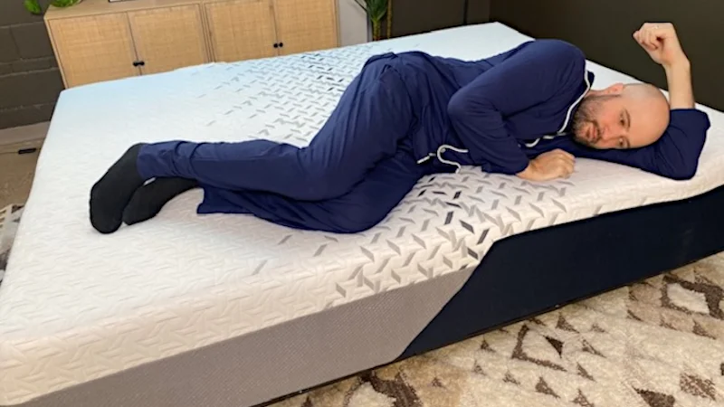 A man lying on his side on the Nectar Luxe Memory Foam.