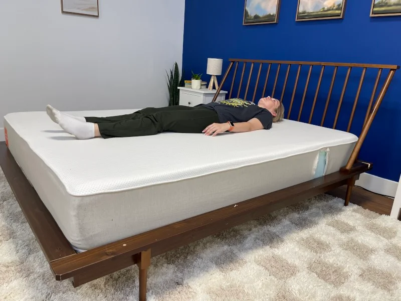Our tester back-sleeping on a Boring Hybrid Mattress