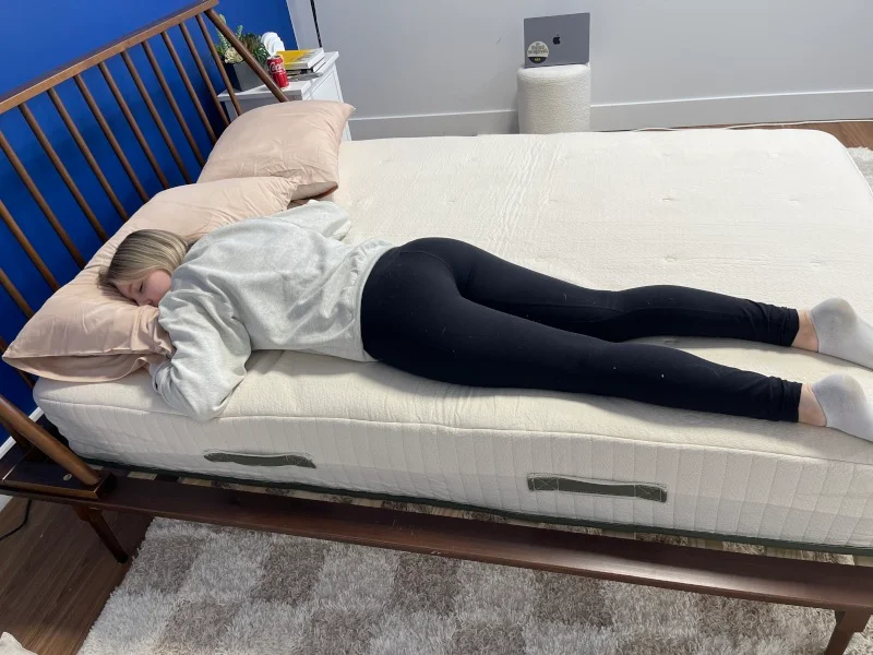 Our tester stomach-sleeping on an Avocado Eco Organic Mattress.
