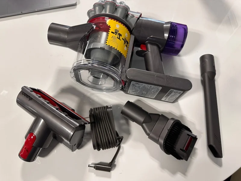 Parts included with a Dyson vacuum cleaner.