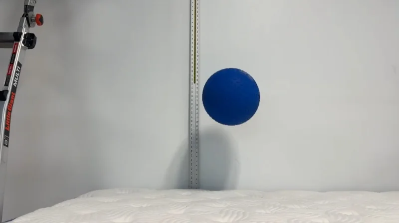 A medicine ball bouncing off a DLX Premier Hybrid mattress during a responsiveness test.