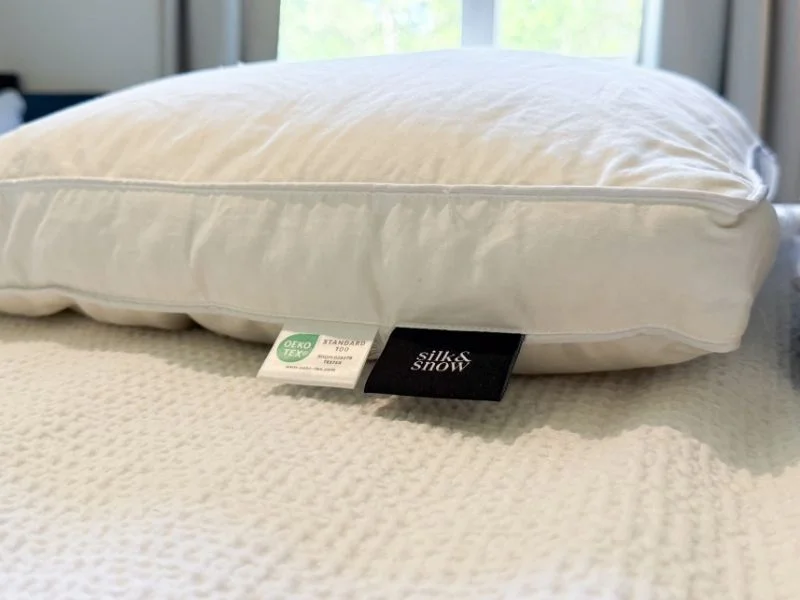 A side view of the Silk & Snow Reserve Down pillow showing the thickness of the pillow.