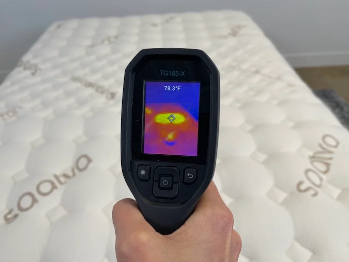 A closeup of someone using a thermal gun to take the temperature of the Saatva Rx after 5 minutes of someone lying on it. The screen reads 78.3 degrees.