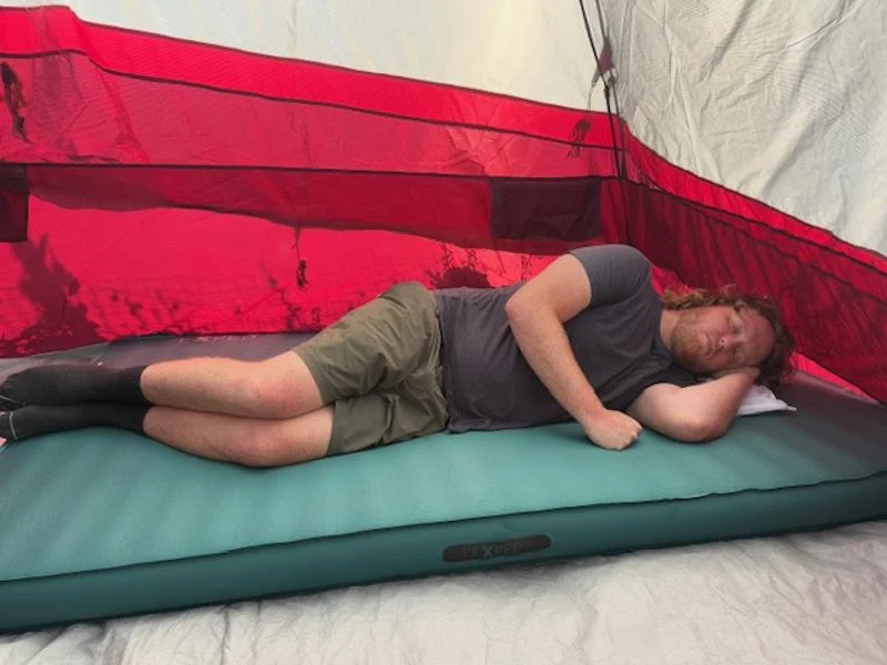 A man sleeps on the Exped MegaMat Duo
