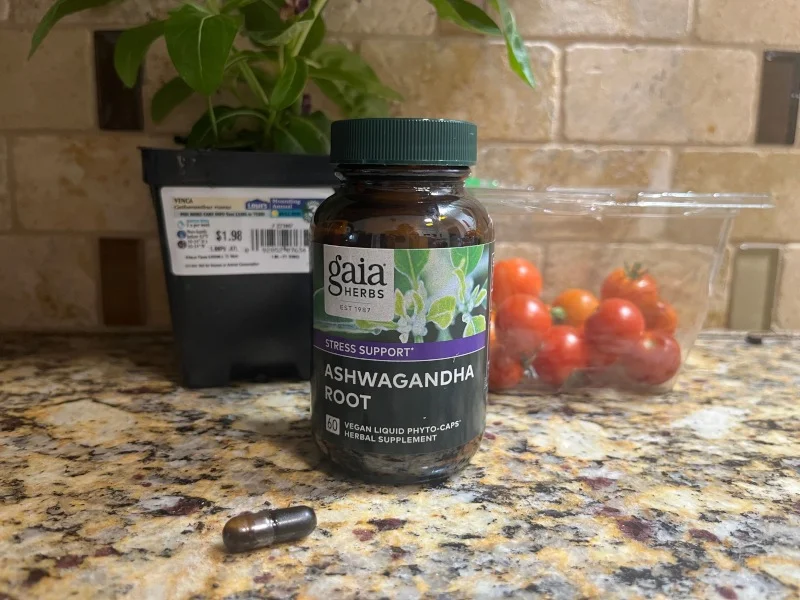 A capsule and bottle of Gaia Ashwaganda Root on our tester's kitchen counter.