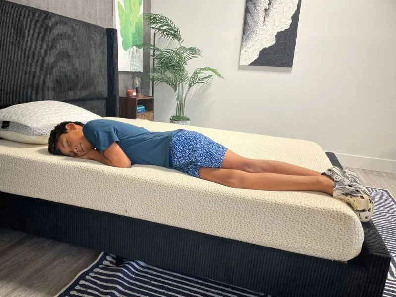 Our tester side-sleeping on a 5 Little Monkeys Memory Foam Mattress