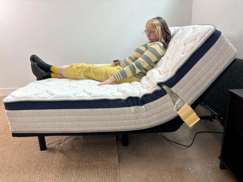 Our tester assesses the Helix Midnight mattress on an adjustable bed.