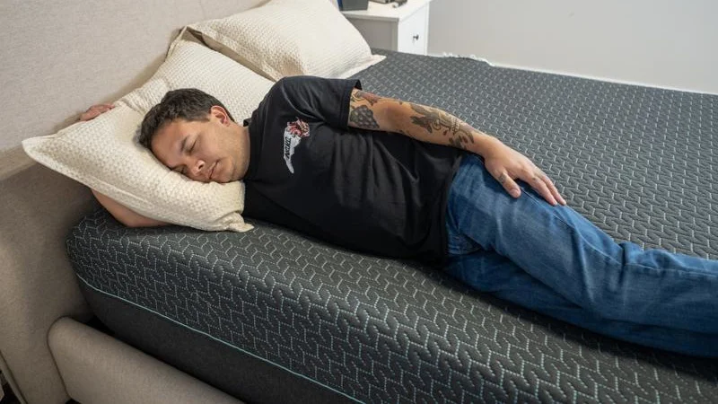 Our tester side sleeping on the Tuft & Needle Mint Hybrid Mattress