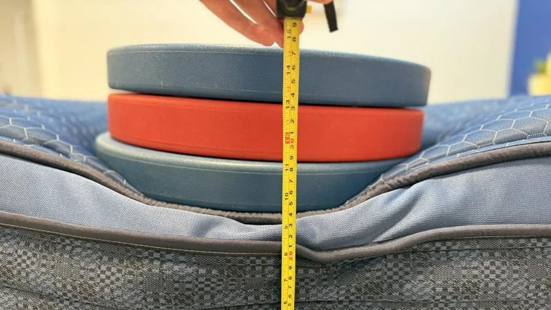 Measuring the deflection of weight plates along the edge of the Brooklyn Bedding Signature Hybrid Mattress