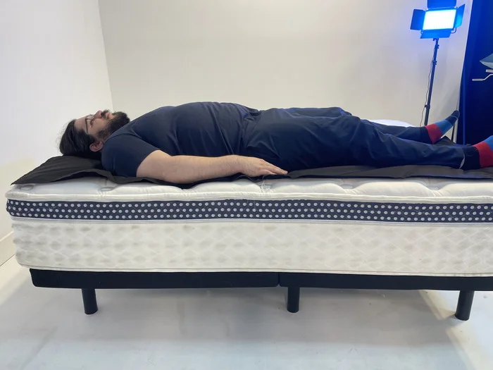 A man lying on the WinkBed on his back.