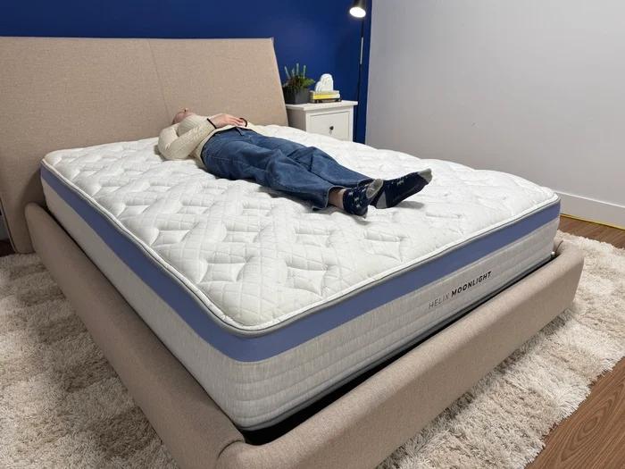 A young woman lies on her back on the Helix Moonlight