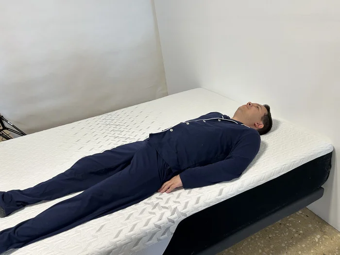 A person is shown back sleeping on the Nectar Mattress