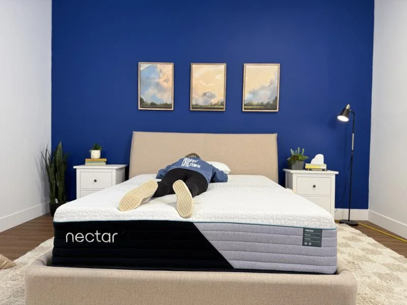 Our tester stomach-sleeping on the Nectar Premier Hybrid Mattress