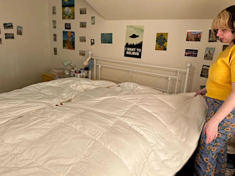 Livvi making a bed with a Coop Sleep Goods Adjustable Comforter