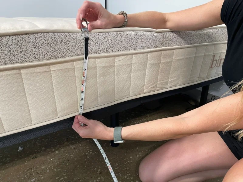 Our Tester measuring a Birch Luxe Natural Mattress