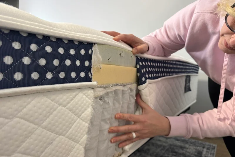 A mattress tester inspects the layers of the WinkBed Plus.