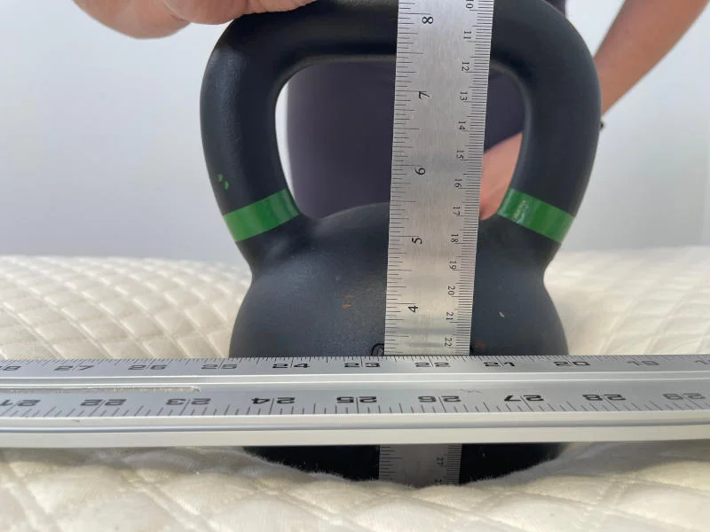 Our tester conducting a sinkage test on the Nolah Signature Mattress