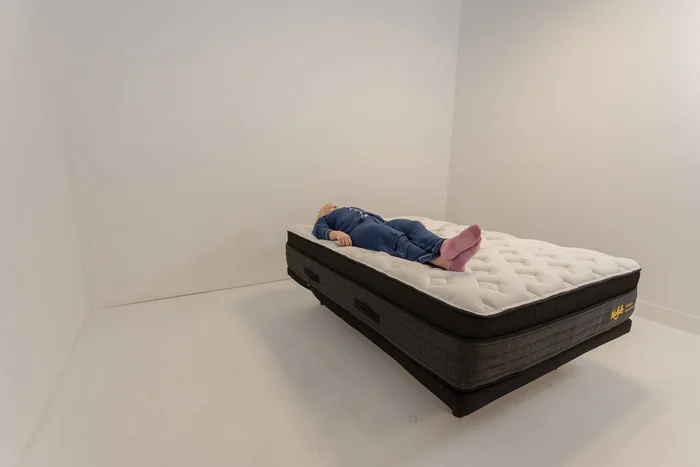 A woman lying on the Nolah Evolution mattress in the back-sleeping position.