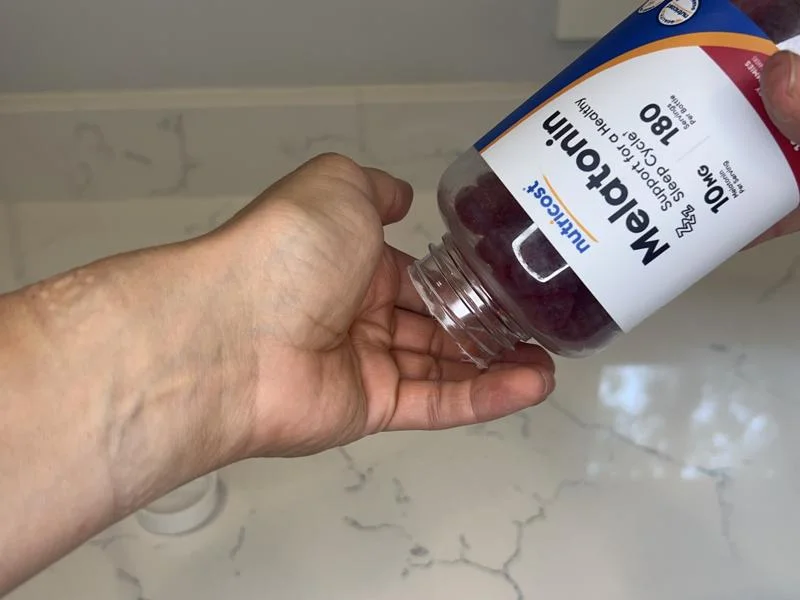 Pouring out a bottle of Nutricost Melatonin Gummies