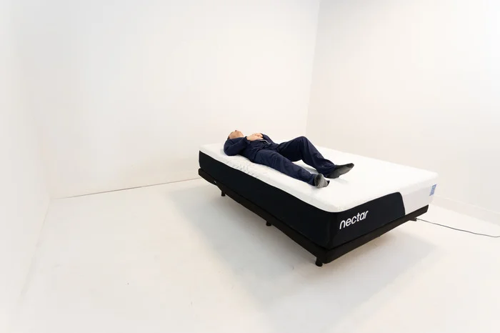 A man back sleeping on the Nectar mattress.