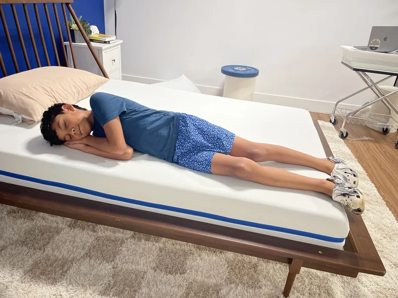 Our young tester side-sleeping on the Nectar Kids Mattress