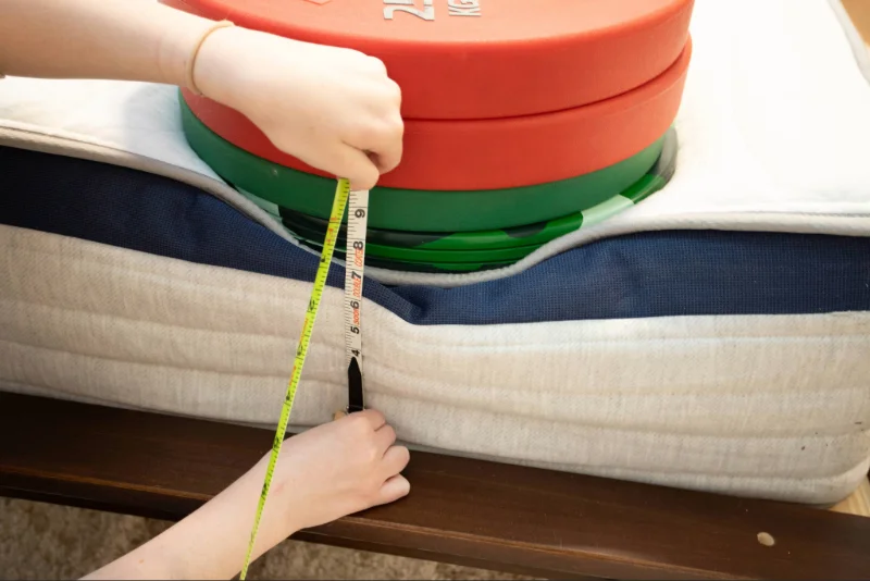 A mattress tester using weights to assess the edge support of the Helix Midnight.