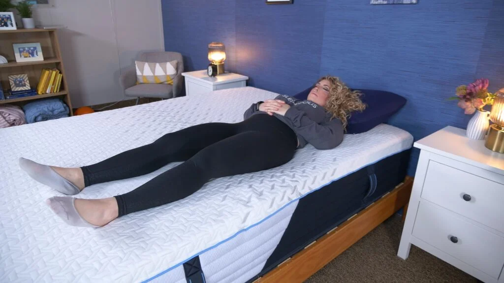 A person is shown back-sleeping on a Nectar Classic Hybrid mattress.