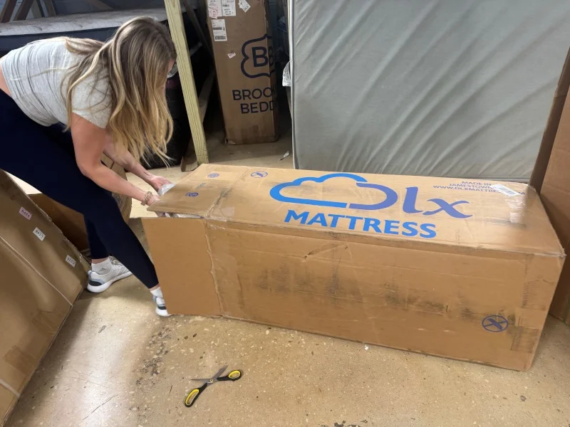 Our tester unboxes a brand new DLX Premier Hybrid mattress.