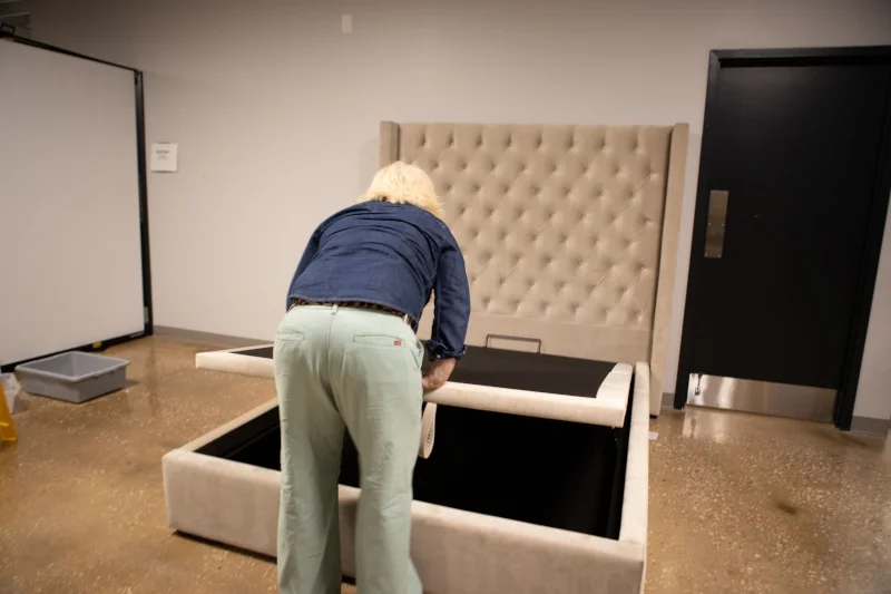 Our tester leans to open a Saatva Amalfi Storage Bed