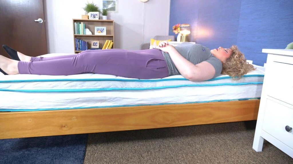 Nichole testing the edge support of the Linenspa Hybrid Mattress.