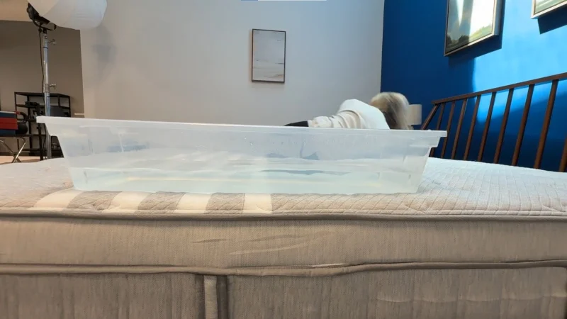 Our tester performs a ripple test on a Leesa Plus Hybrid Mattress