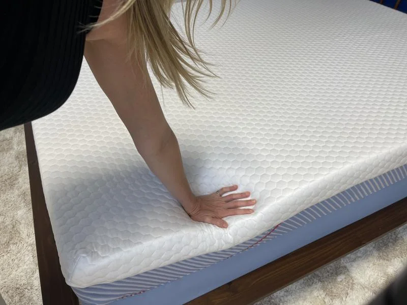 Our product tester leans on the Bear Pro Topper to do a responsiveness test