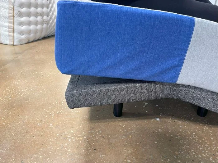 The corner of a Casper The One mattress on an adjustable base.
