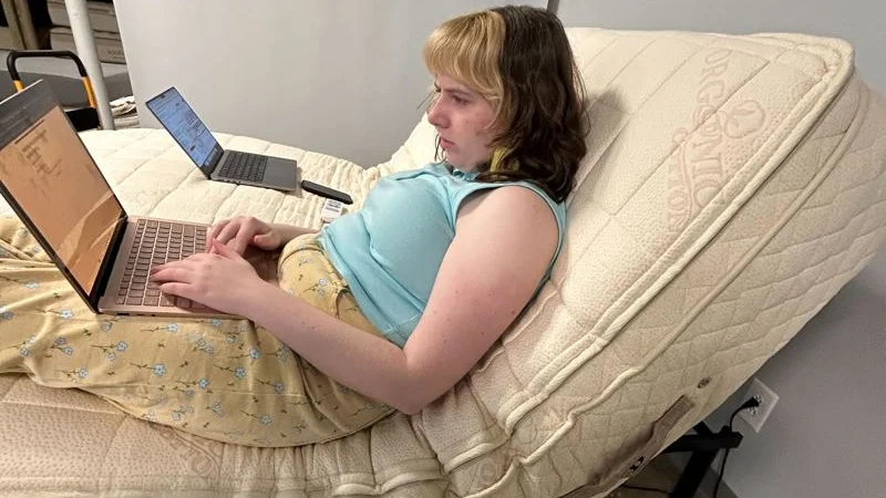 PlushBeds Botanical Bliss Mattress on an adjustable bed with our tester