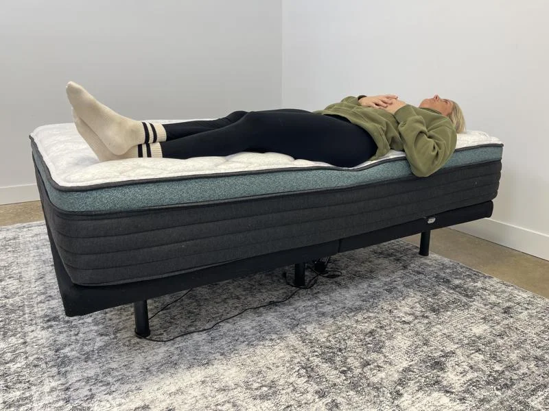 Our tester performs a back-sleeping full body edge support test of the Helix Sunset Luxe Mattress