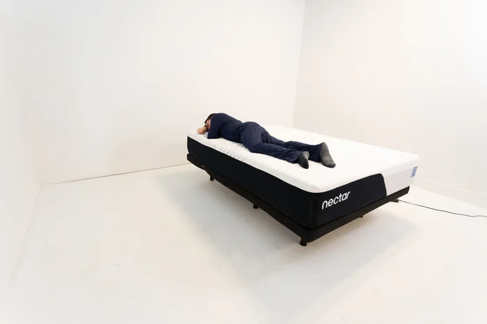 A man stomach sleeping on the Nectar mattress.