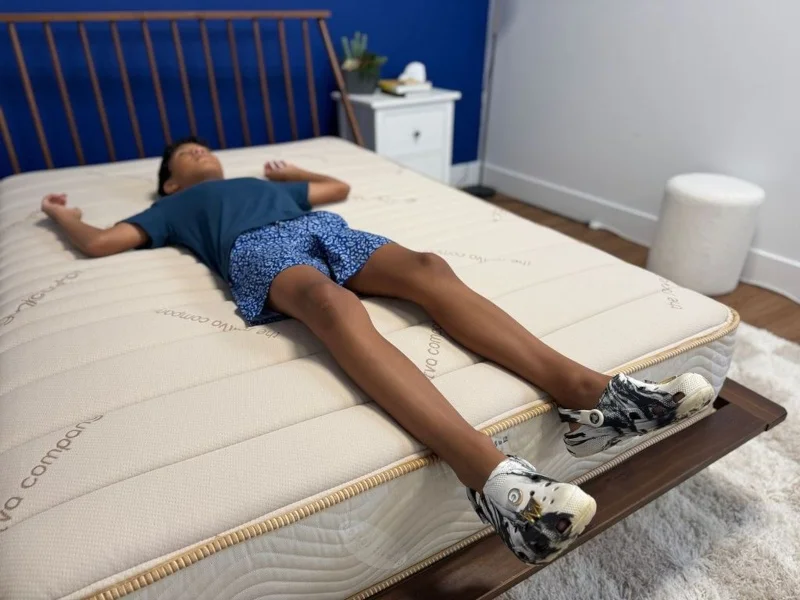 Our tester back-sleeping on a Saatva Youth Mattress